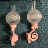 Original wall lights in pink enamelled cast iron with frosted glass globes.