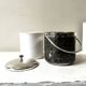 Vintage chrome metal ice bucket with black marbled design, 1970s style.