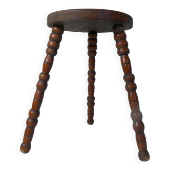 old tripod stool in beaded wood for plants