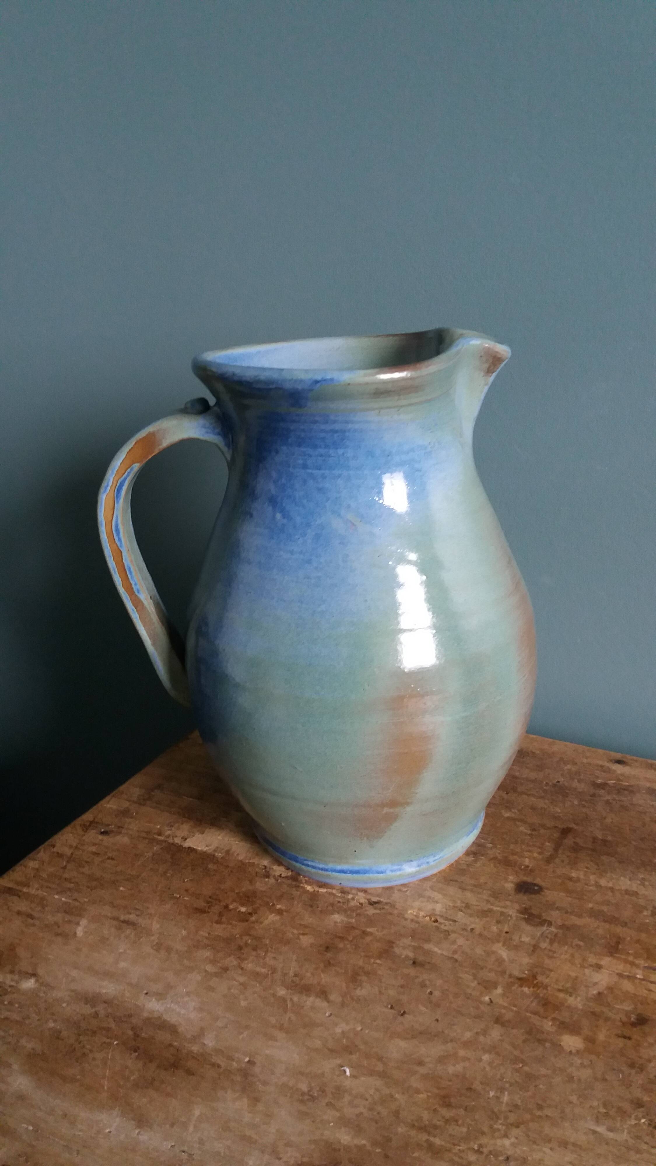 Enamel pitcher in pastel blue and green, signed