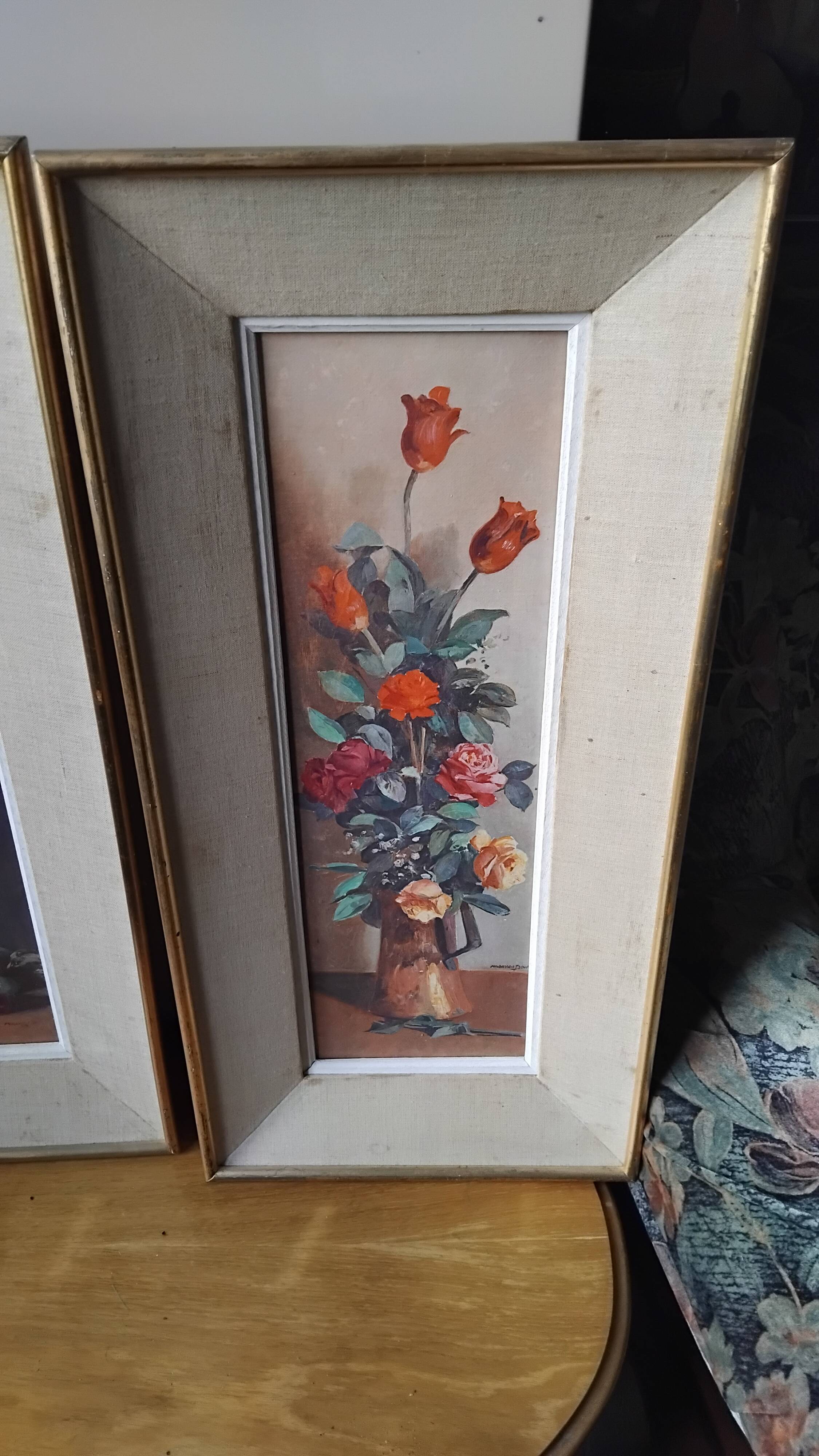 Pair of framed paintings featuring a composition of flowers.