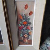 Pair of framed paintings featuring a composition of flowers.