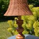 Large wooden lamp with a woven rattan shade.