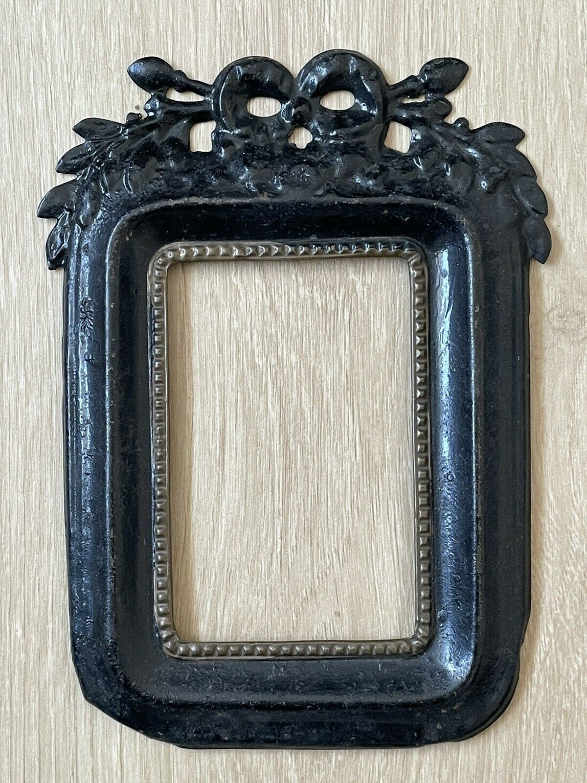 Black metal frame knot and laurel branch