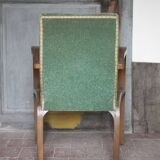 Art Deco armchair in wood and green fabric, living room armchair, interior decor.