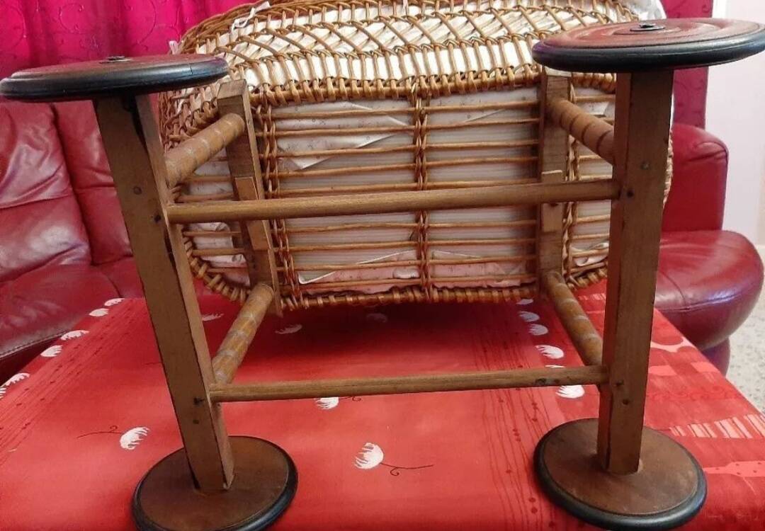 Vintage wicker cradle on wheels from the 1970s.