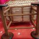 Vintage wicker cradle on wheels from the 1970s.