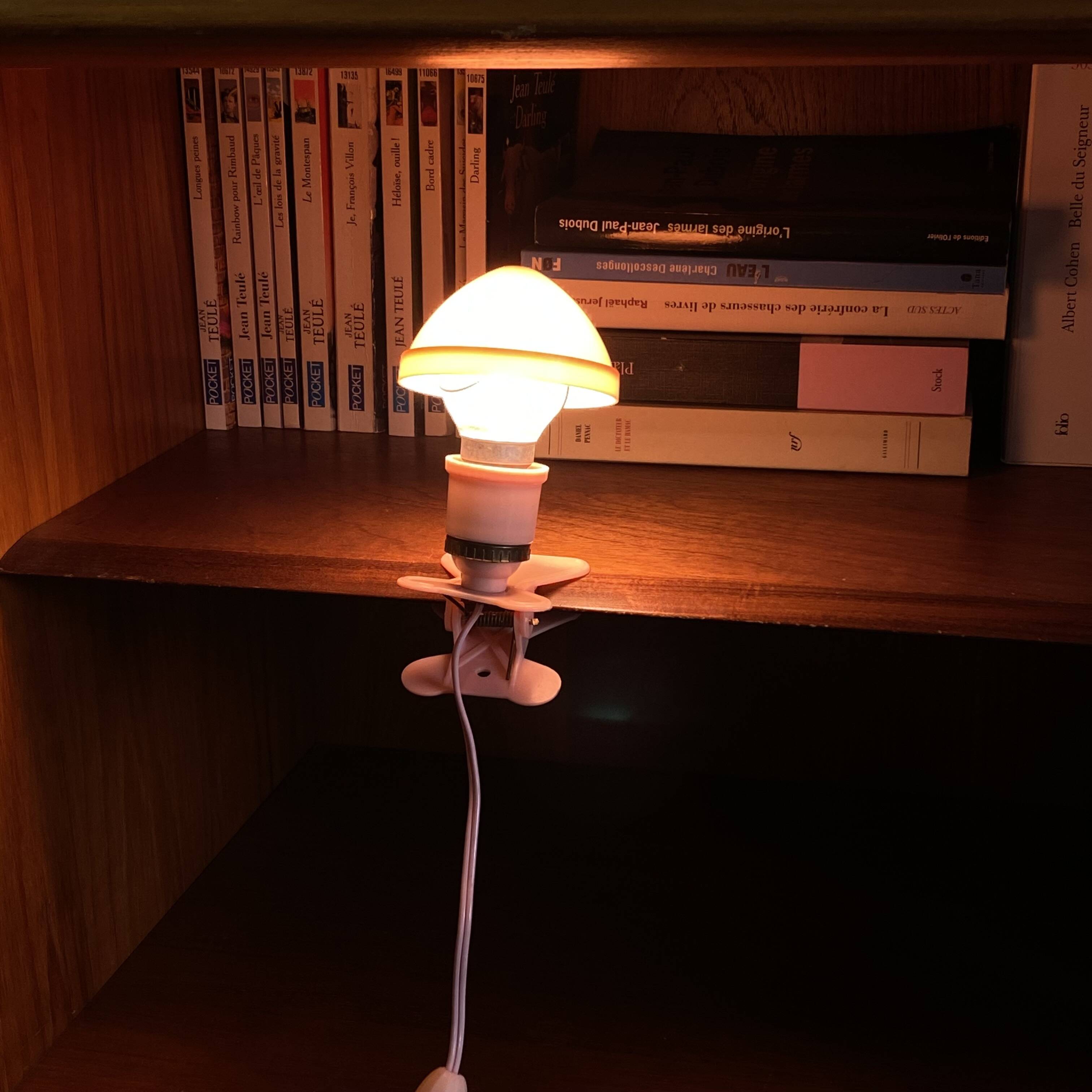 Small portable pink plastic mushroom clip-on lamp