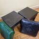 Pair of Moroccan poufs in stamped leather with a carved wooden base, Rabat