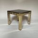 Set of three nesting side tables in brass and smoked mirror.