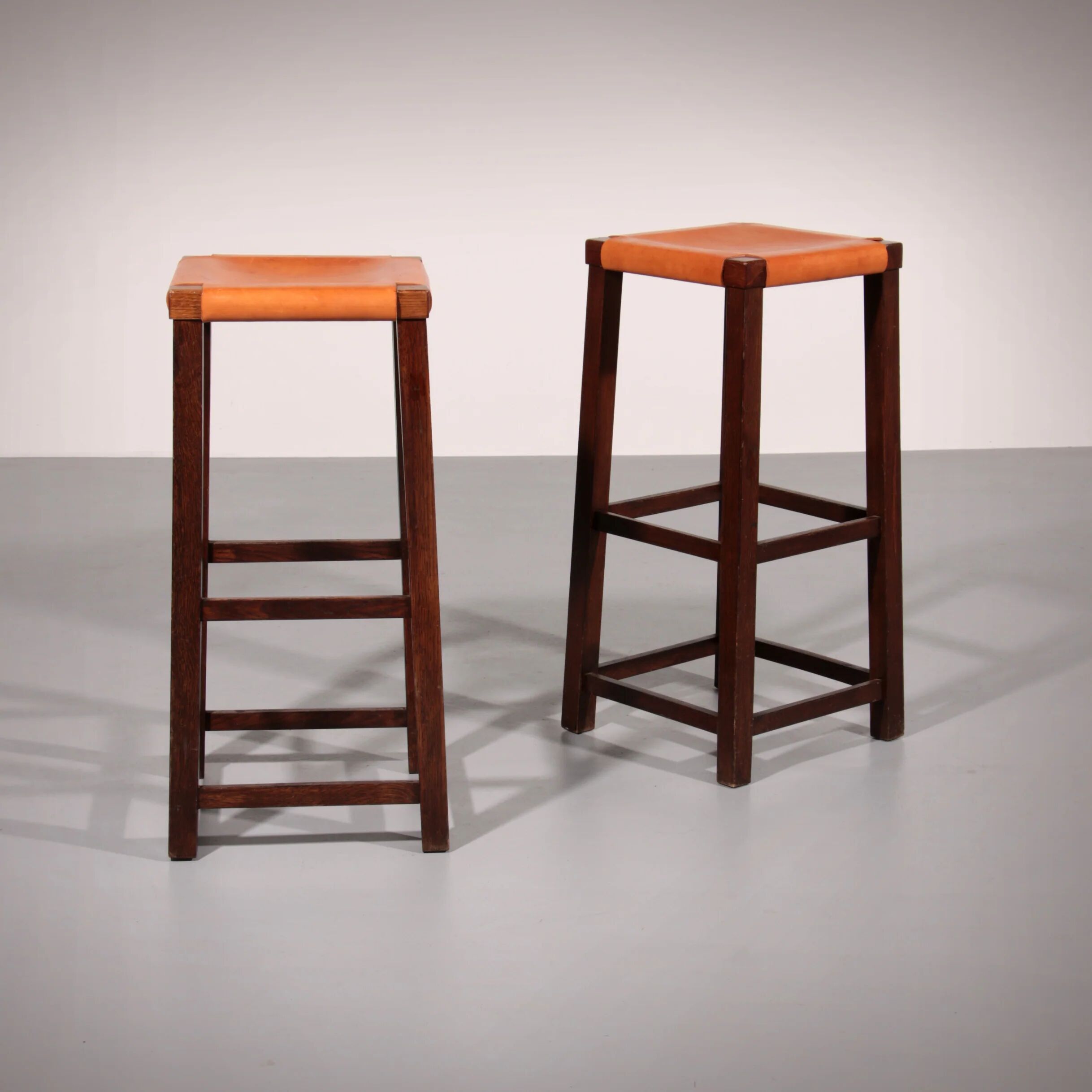 Mid-century oak bar stools with cognac leather seats