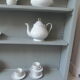 Vintage shallow bookcase, re-enchanted in gray green, wooden tray.