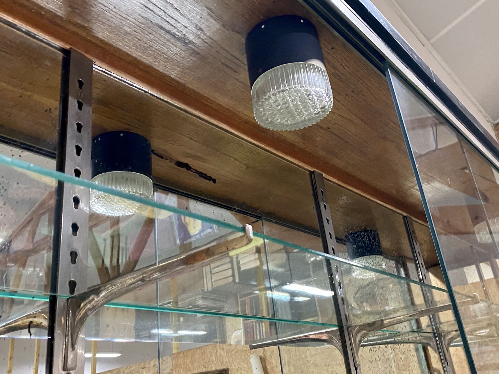 Store window with sliding doors in matte black patinated oak - 30s