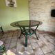 Round bamboo rattan table with a glass top.