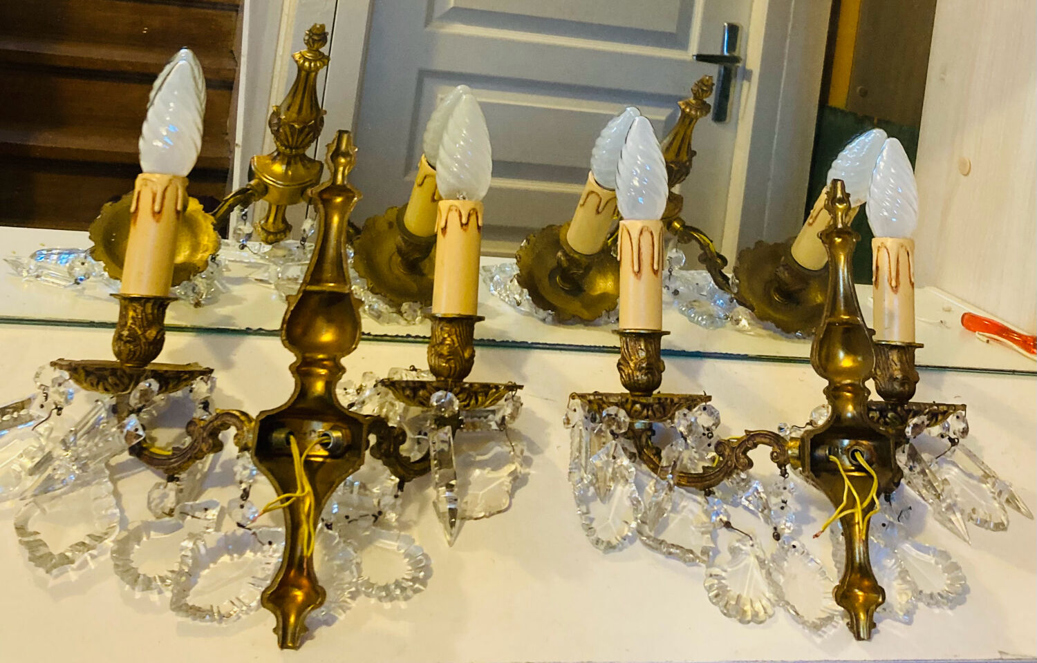 Pair of gilt bronze wall sconces with pendants from the mid-20th century.