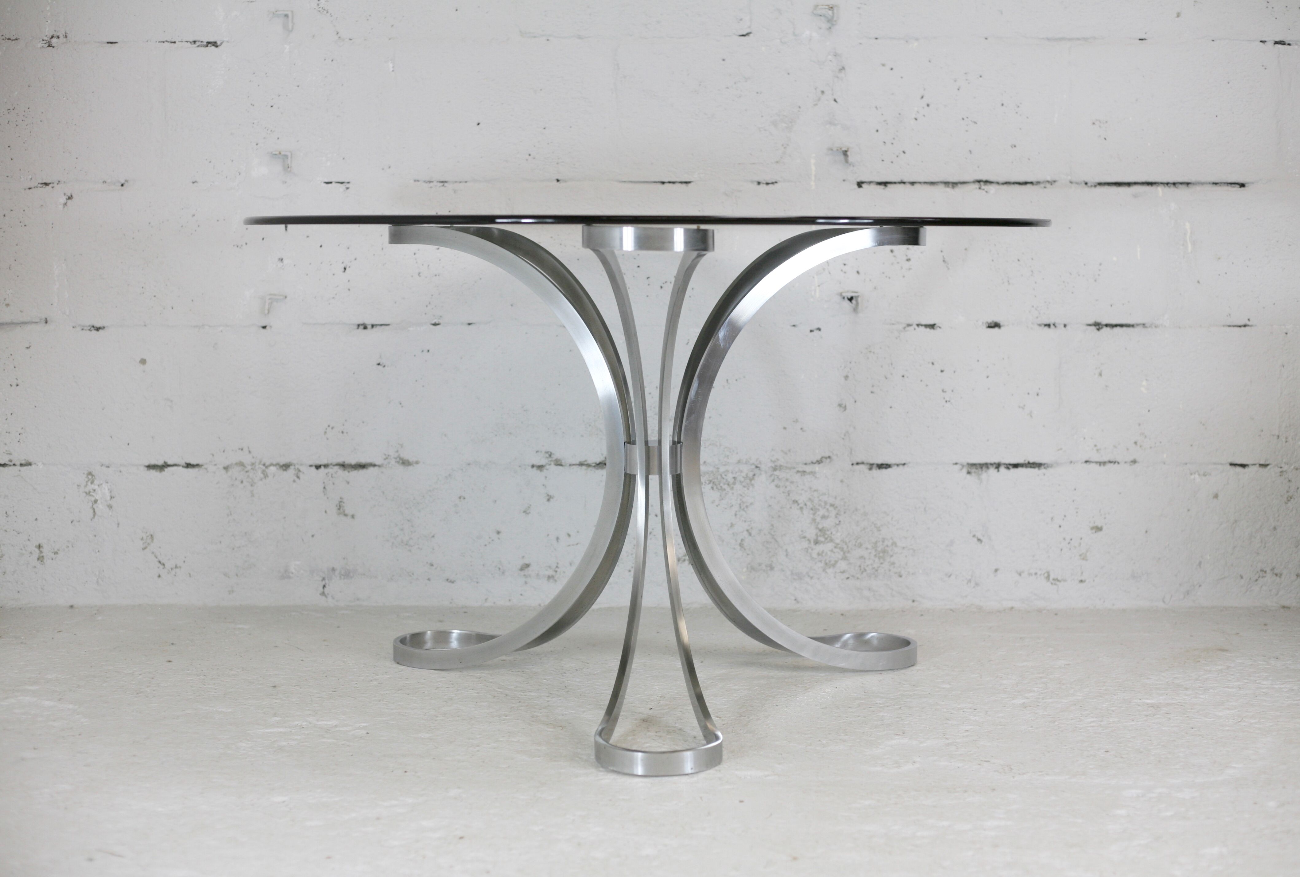 Living room table "Space Age" polished steel, circular slab smoked glass. France, circa 1970.