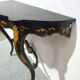Console Napoléon III en bois noirci et fleurs dorées