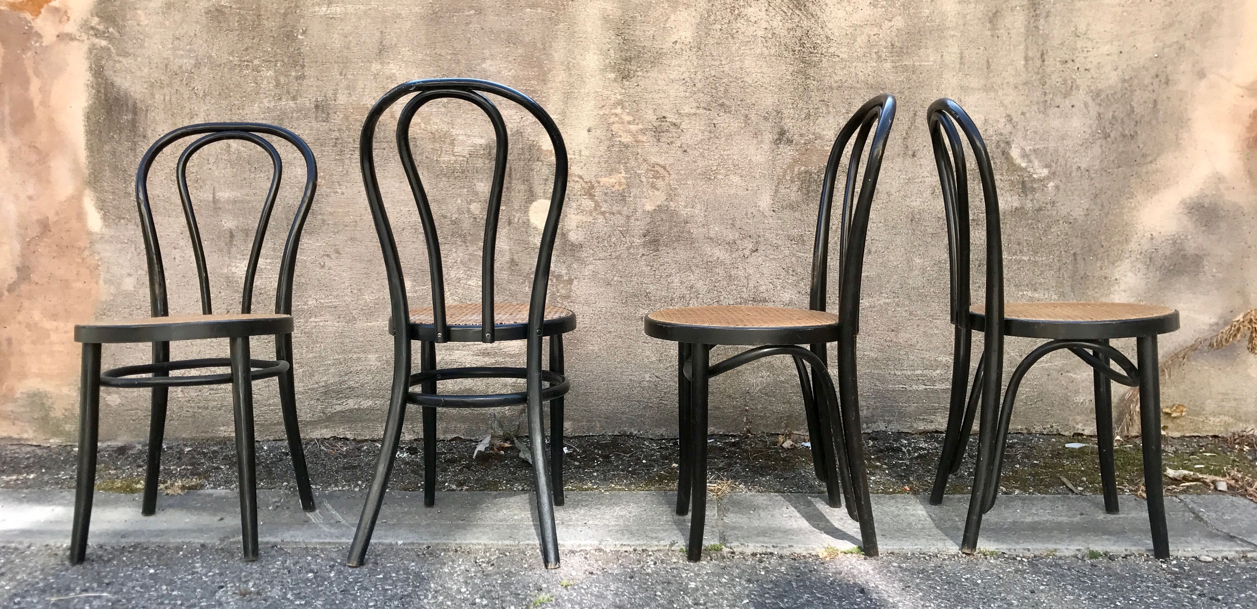 Two pairs of black 50s chairs - number 18 - cannée