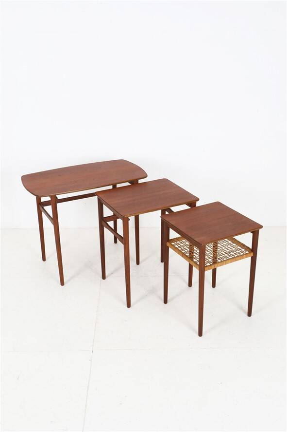 Rare set of three teak nesting tables with cane magazine rack / side tables / mid-century Danish modern design / 1950s / 1960s