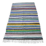 Vintage traditional nomadic kilim ethnic rug with multicoloured stripes.