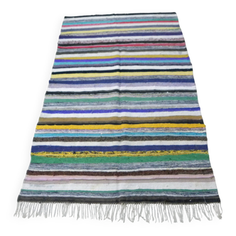 Vintage traditional nomadic kilim ethnic rug with multicoloured stripes.