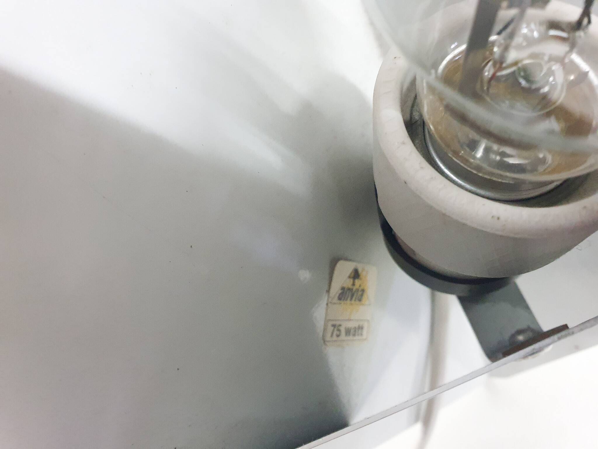 White metal wall light in good condition. By Anvia, The Netherlands.