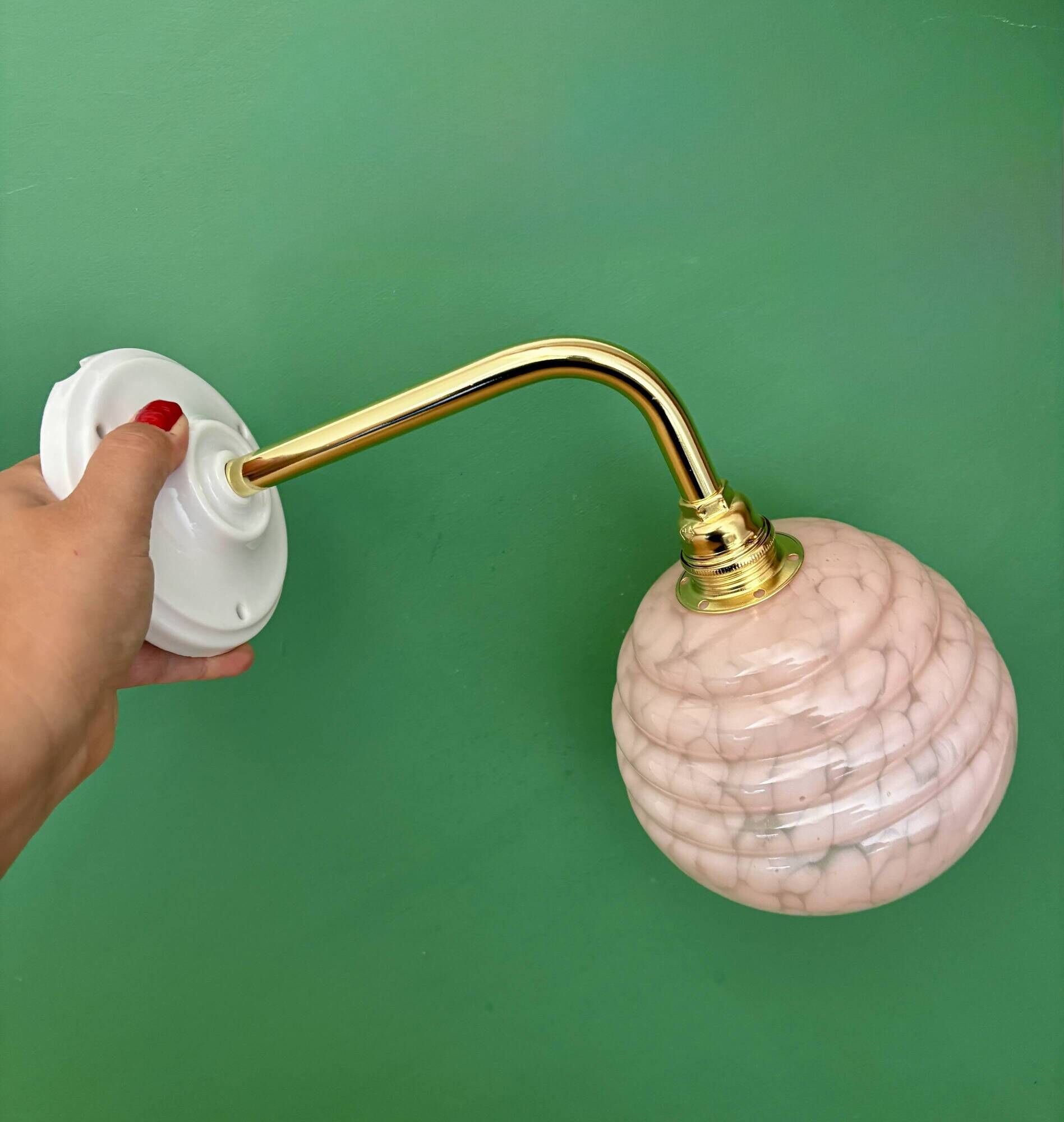 Vintage pink Clichy glass globe wall light.