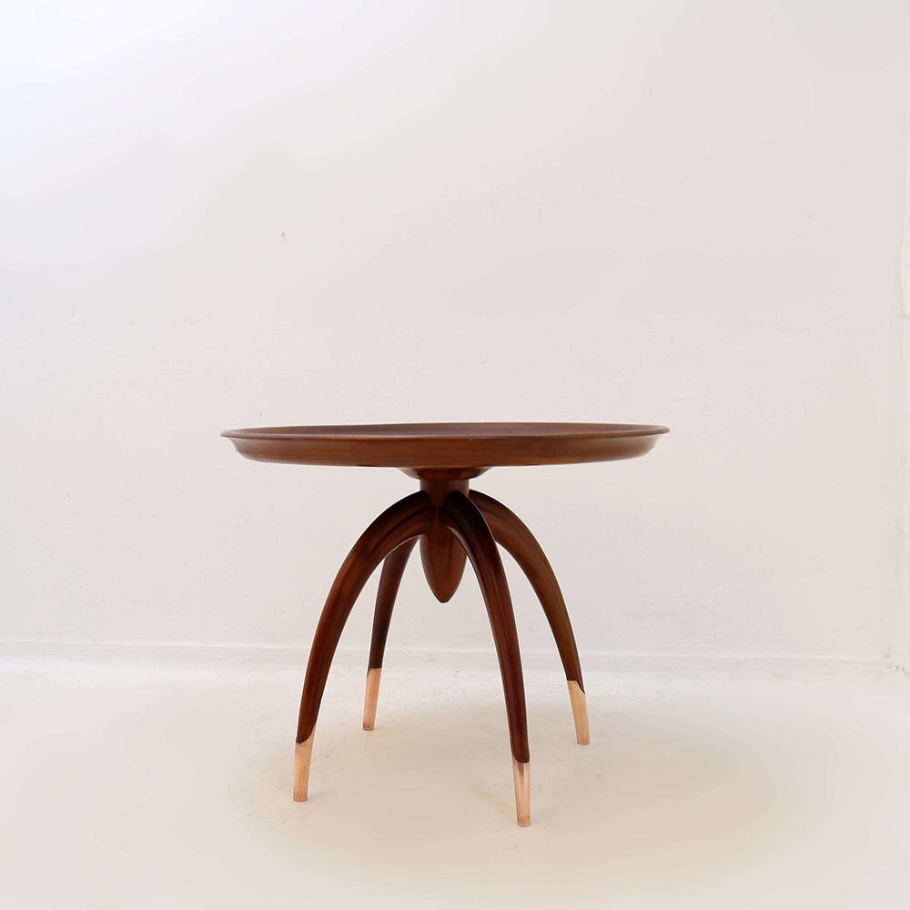 Round Art Deco side table in wood with curved legs and brass feet.
