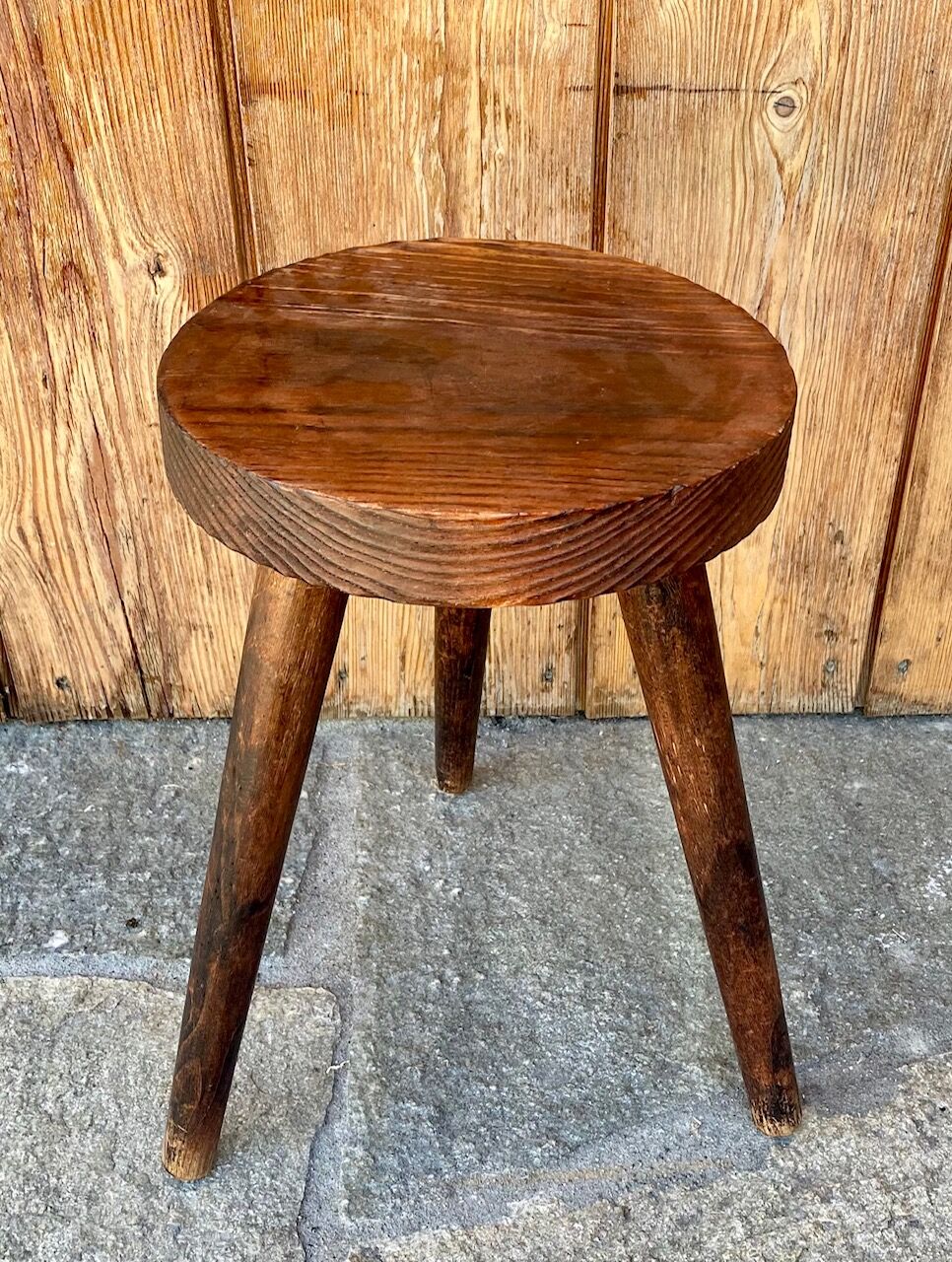 Wooden tripod stool.