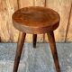 Wooden tripod stool.