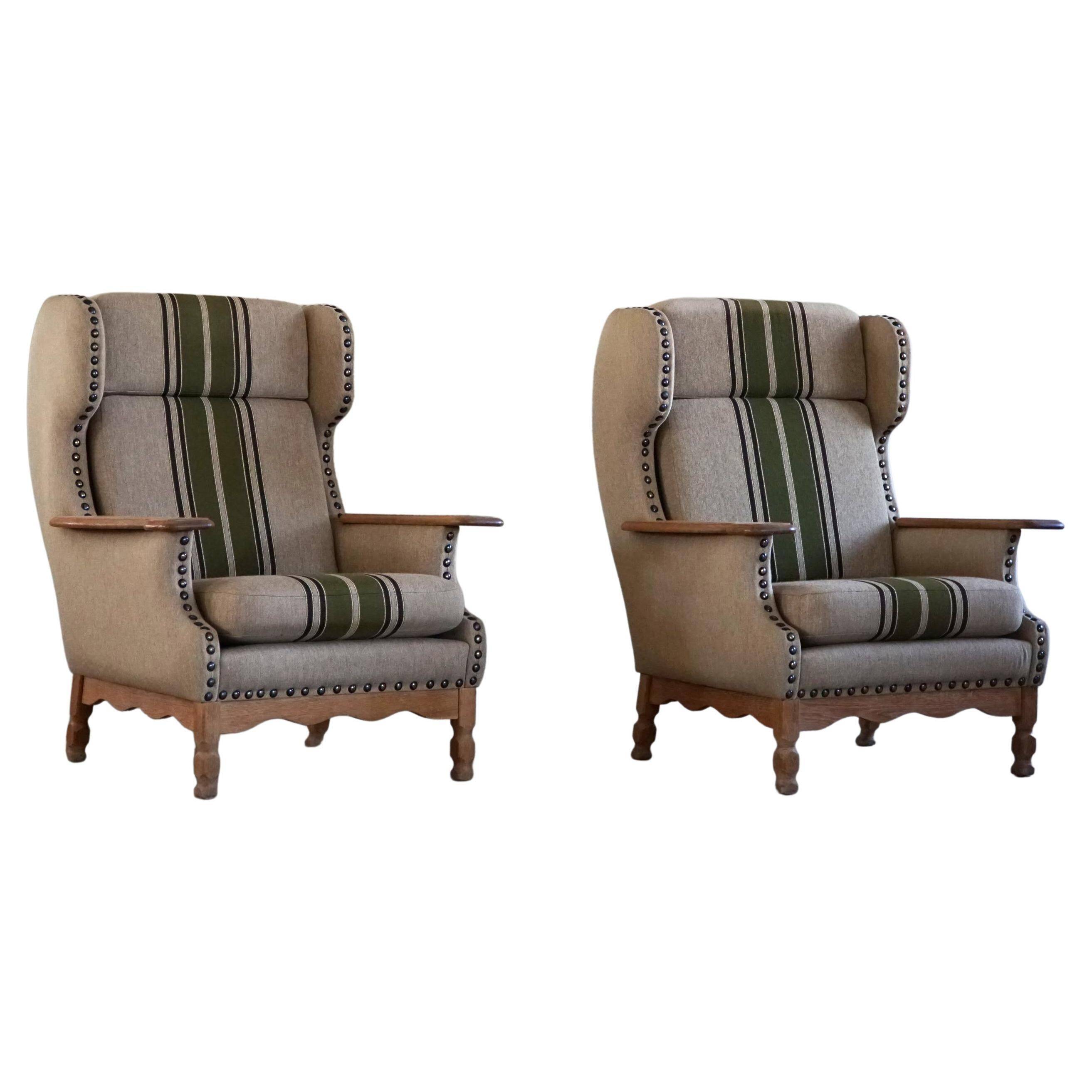 Pair of high-back lounge chairs in modern Danish style in the manner of Henning Kjærnulf, 1960s.