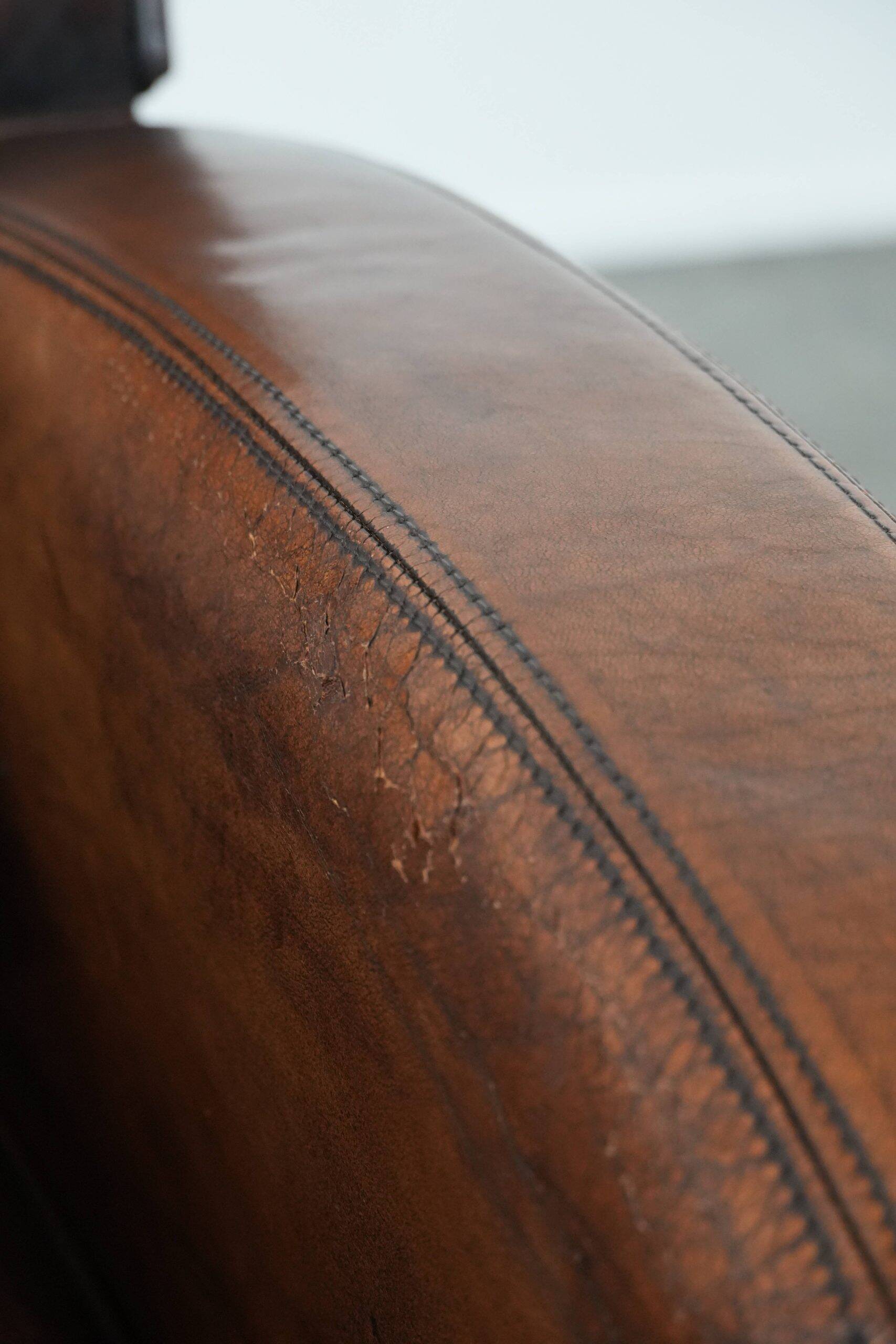 Beautifully shaped vintage sheepskin armchair with character