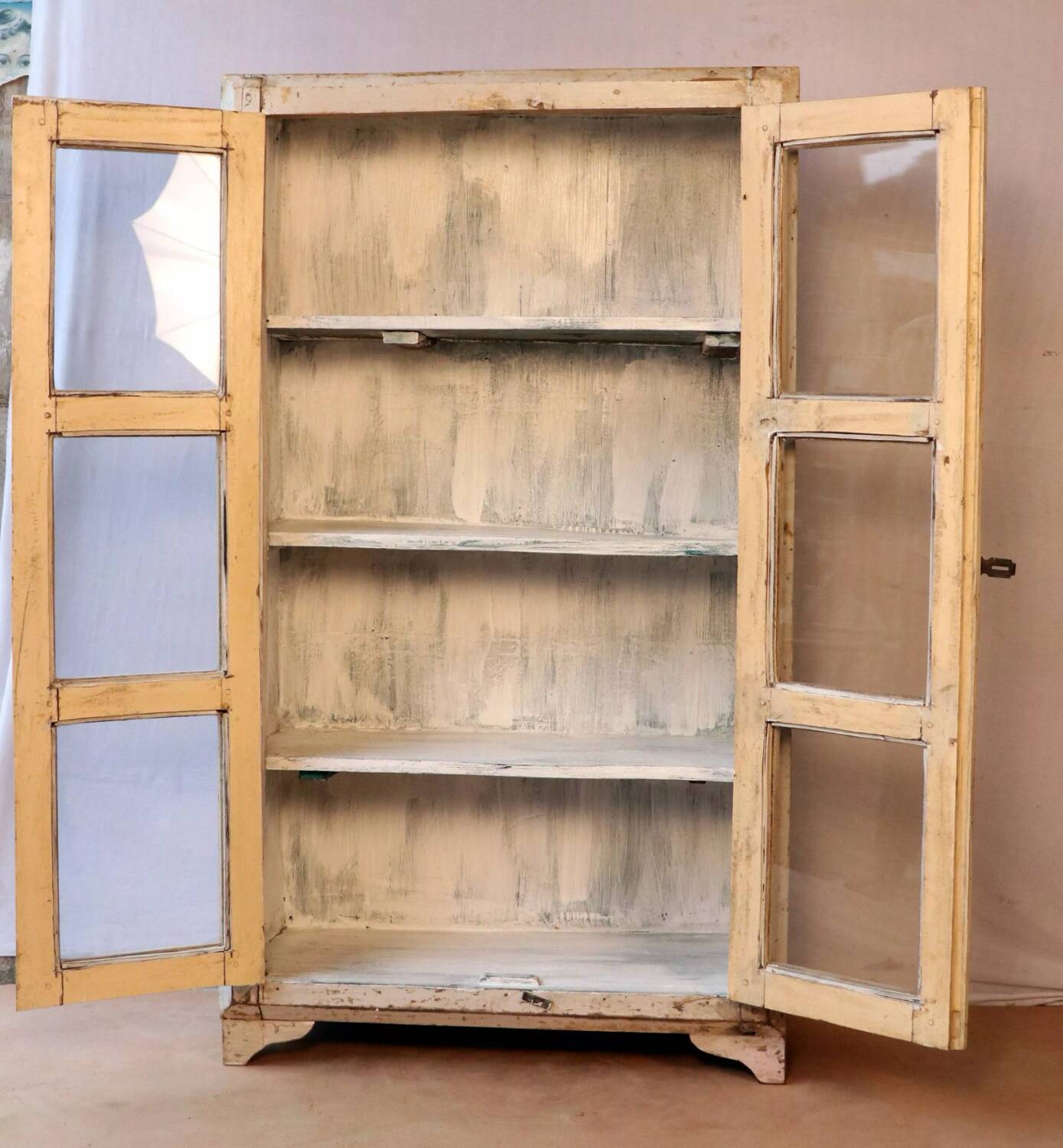 Antique display cabinet in bleached cream teak from Burma.