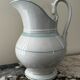 White toilet jug with green trim