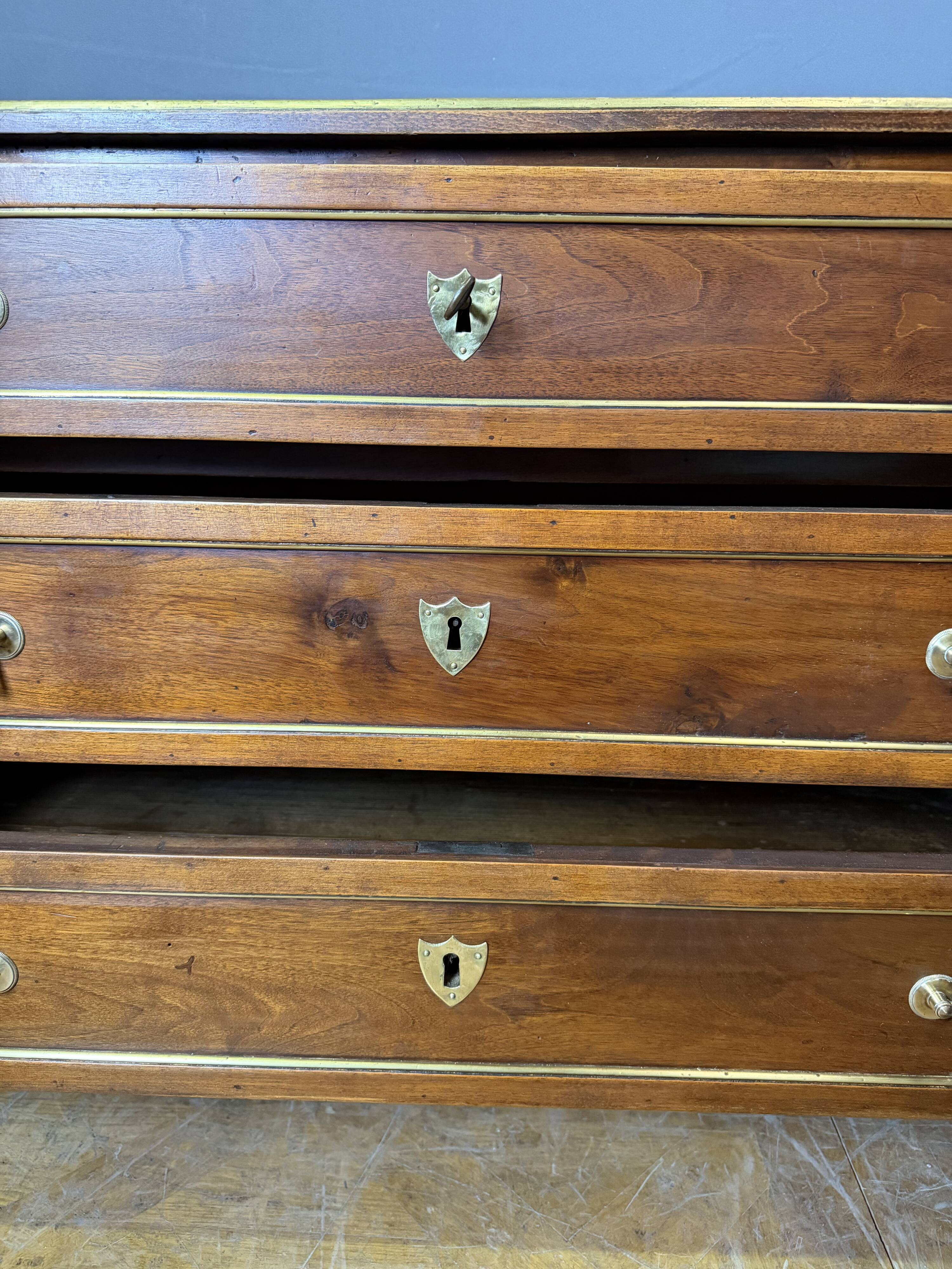 Louis XVI commode in walnut, beech, and brass.