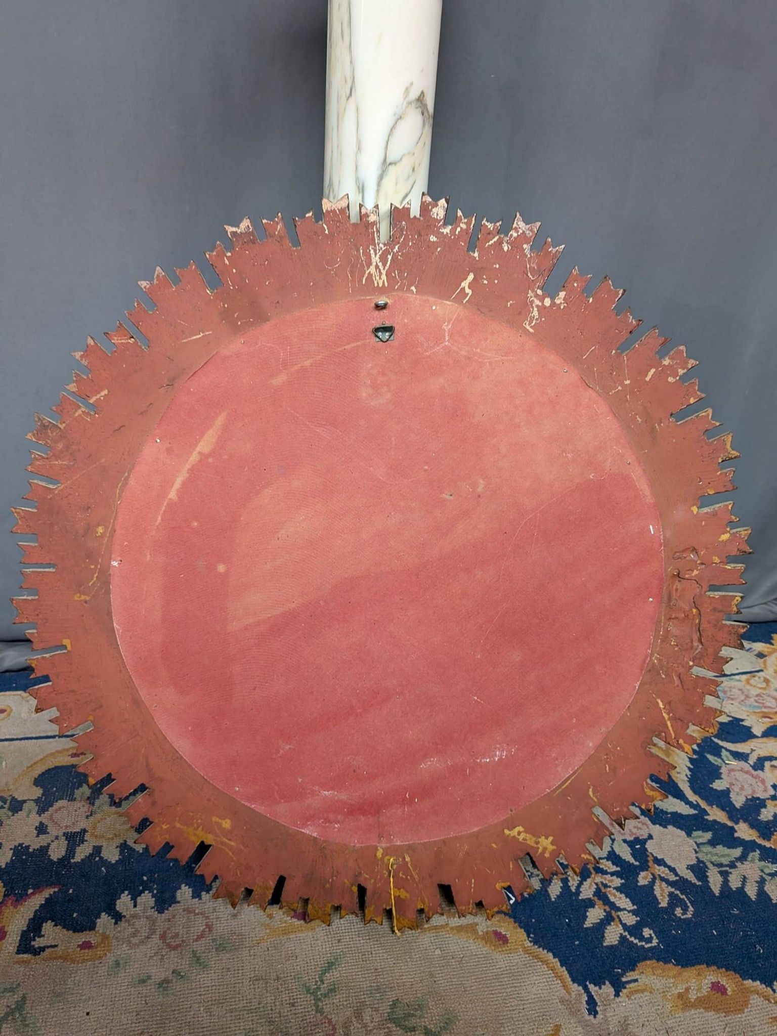 Large wooden mirror with golden sun rays, in Art Deco style.