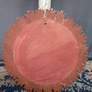 Large wooden mirror with golden sun rays, in Art Deco style.