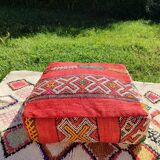Handwoven floor pouf in natural wool