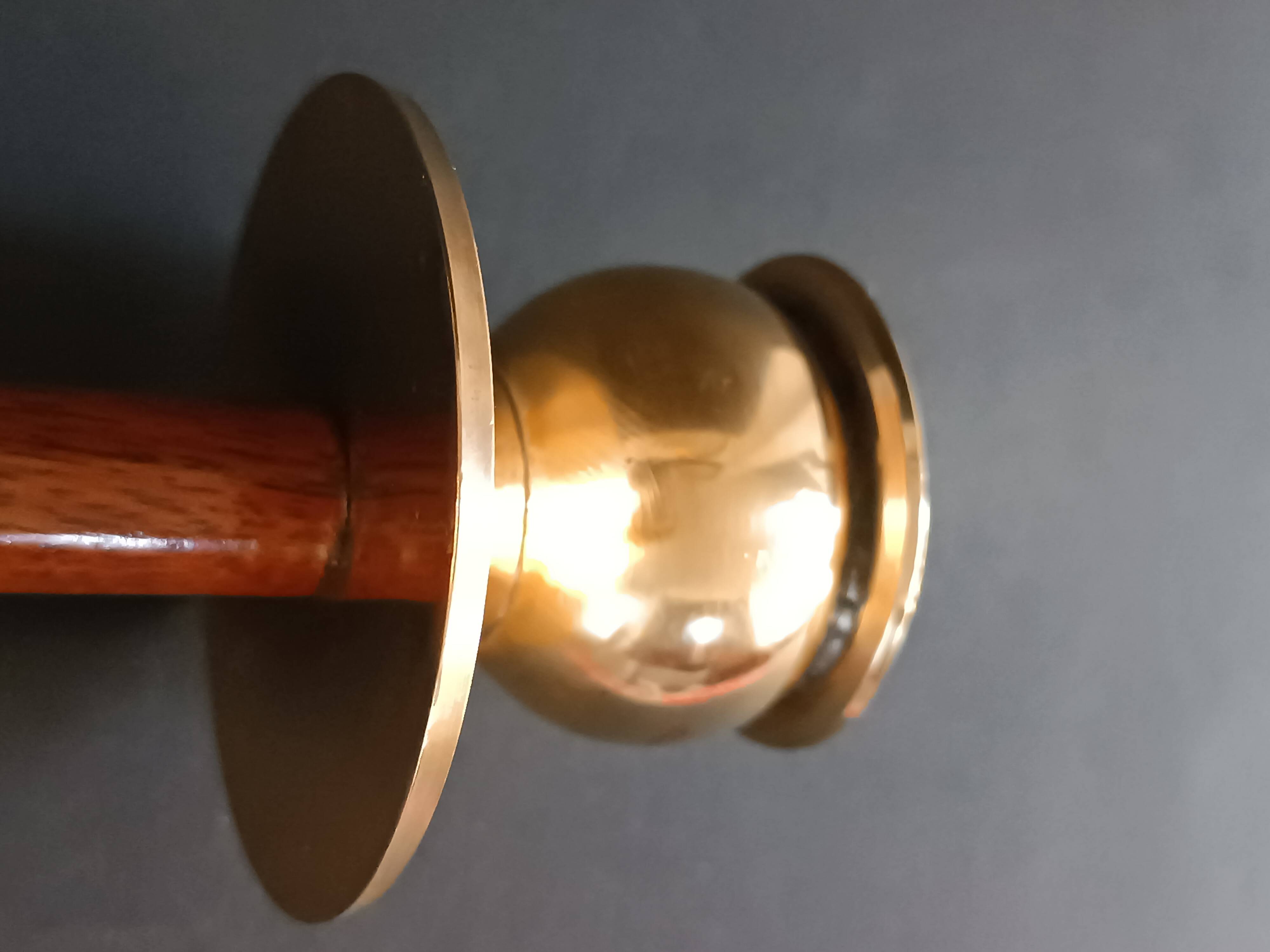 Two vintage wooden and brass candlesticks.