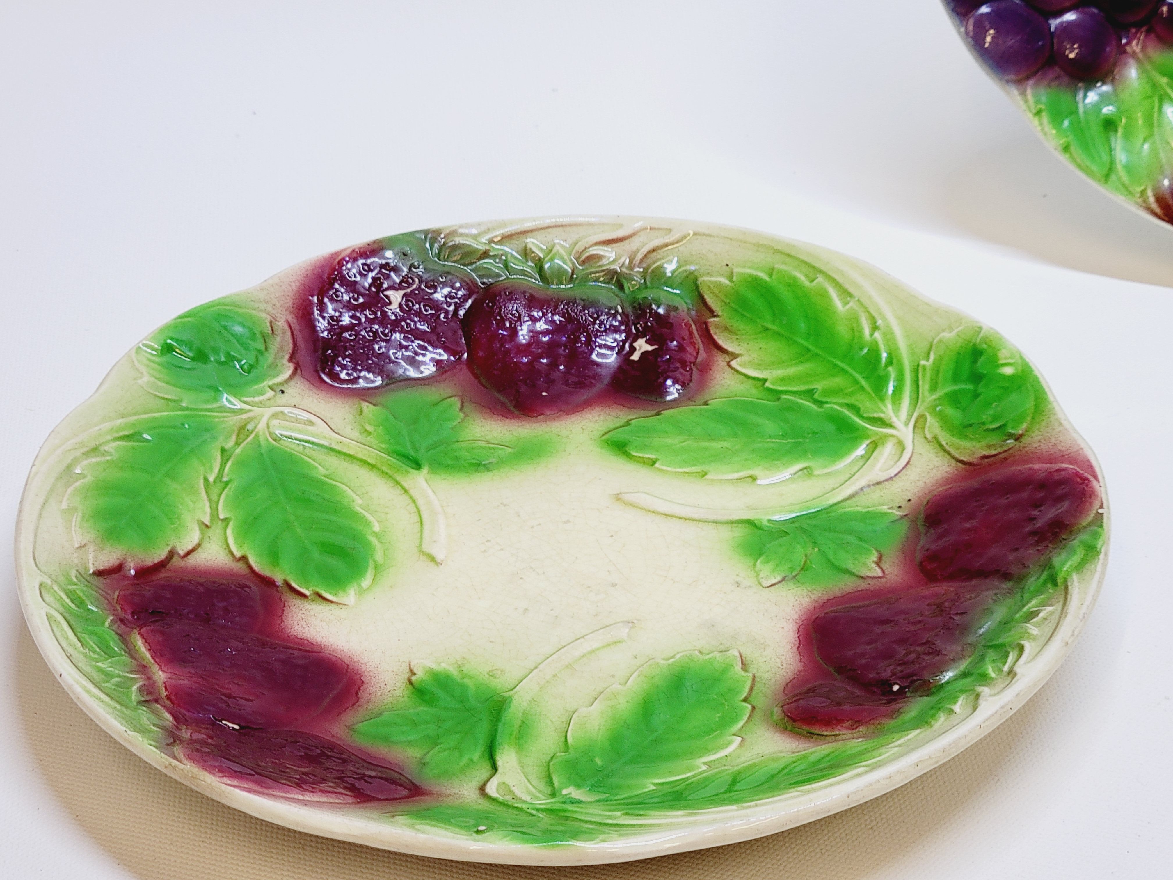 3 old plates in slip decoration strawberries and grapes