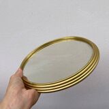 Round mirror in gold metal
