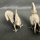 Showcase objects, two 20th century metal rooster and hen subjects