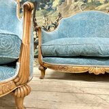 Art deco living room around 1920 in carved wood upholstered in blue velvet, a sofa two armchairs