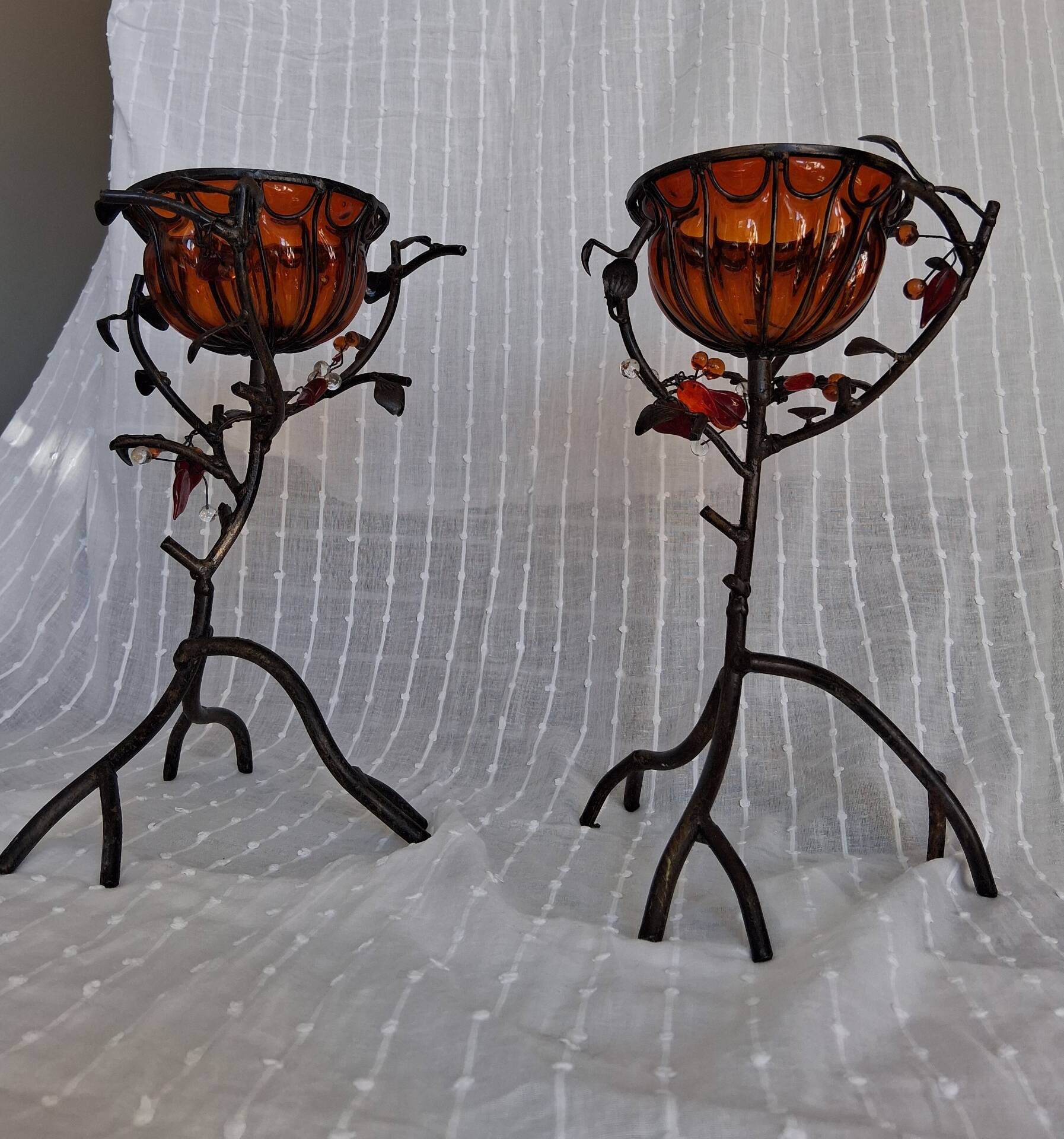 Pair of Art Deco style candle holders in wrought iron and amber blown glass.