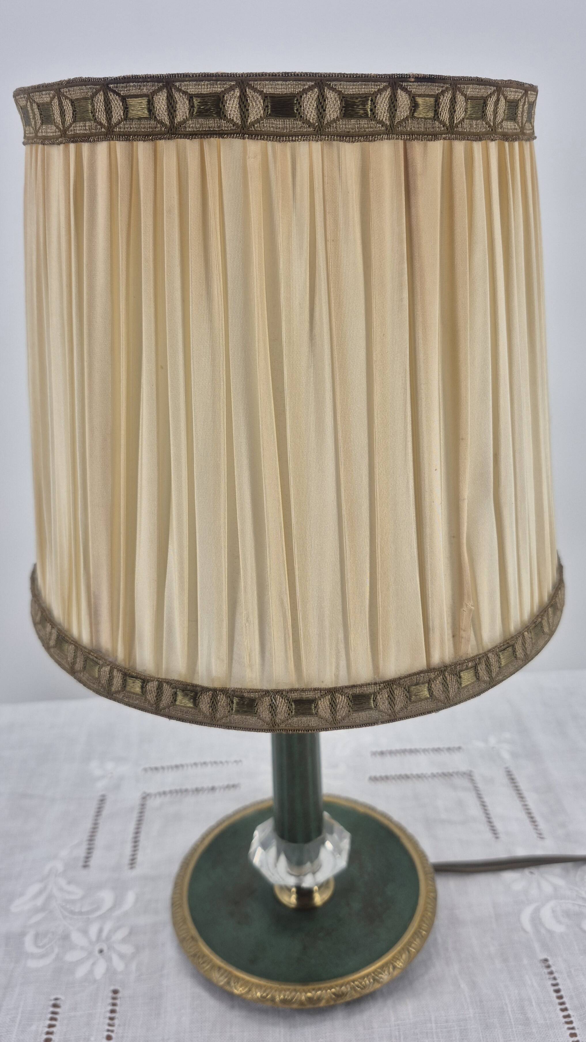 Brass table lamp with green patina and empire-style fabric shade.