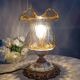 Baroque inspired table lamp, bronze, ceramic flowers and glass globe