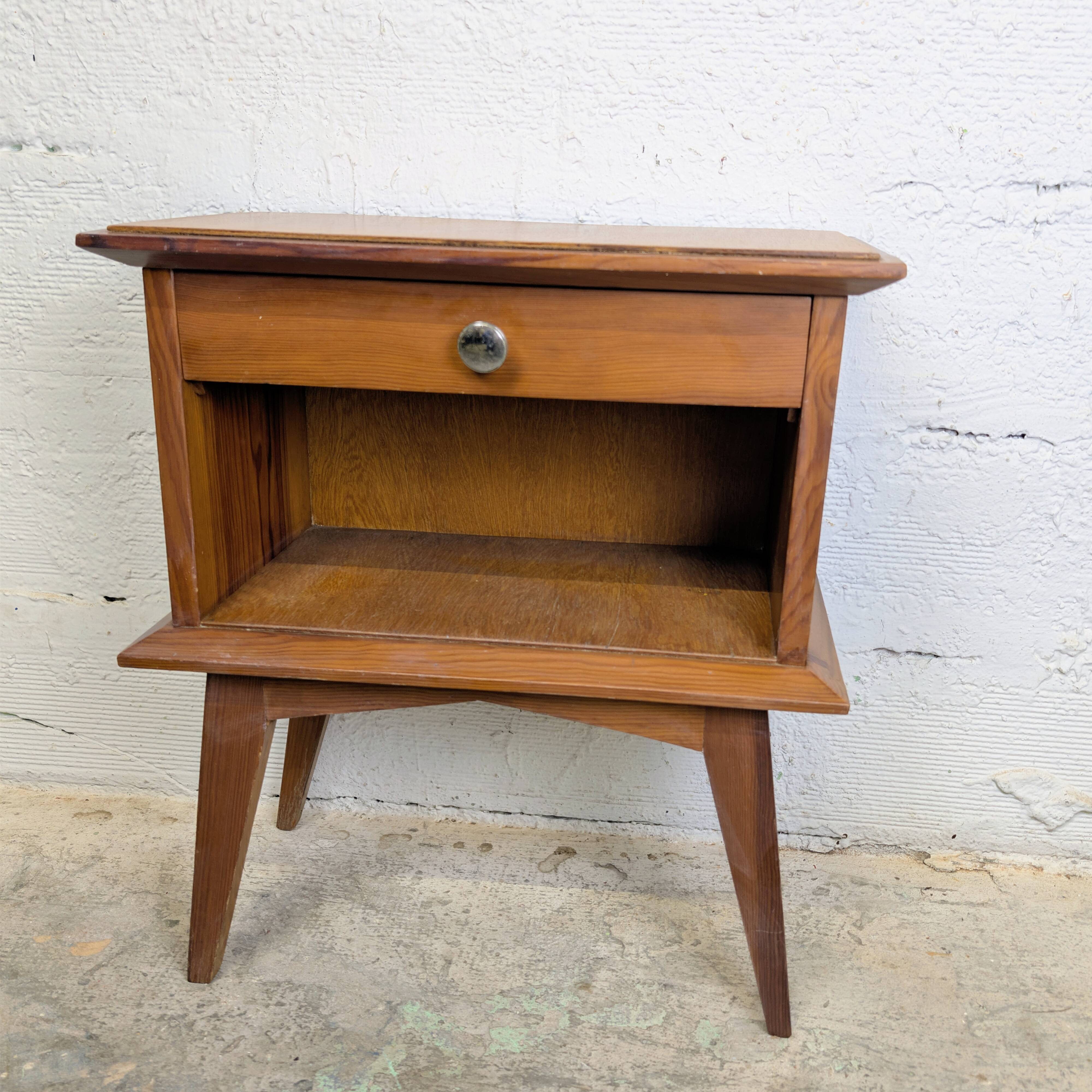 Vintage bedside table with tapered legs.