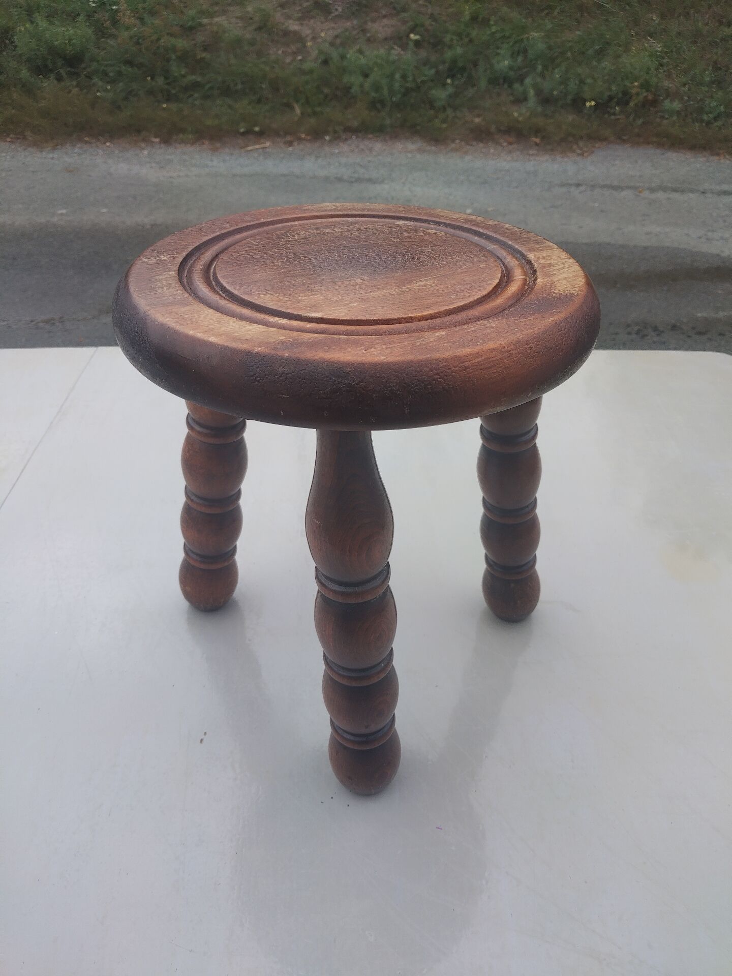 Small vintage tripod stool made of turned wood, in the style of Charles.