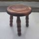 Small vintage tripod stool made of turned wood, in the style of Charles.