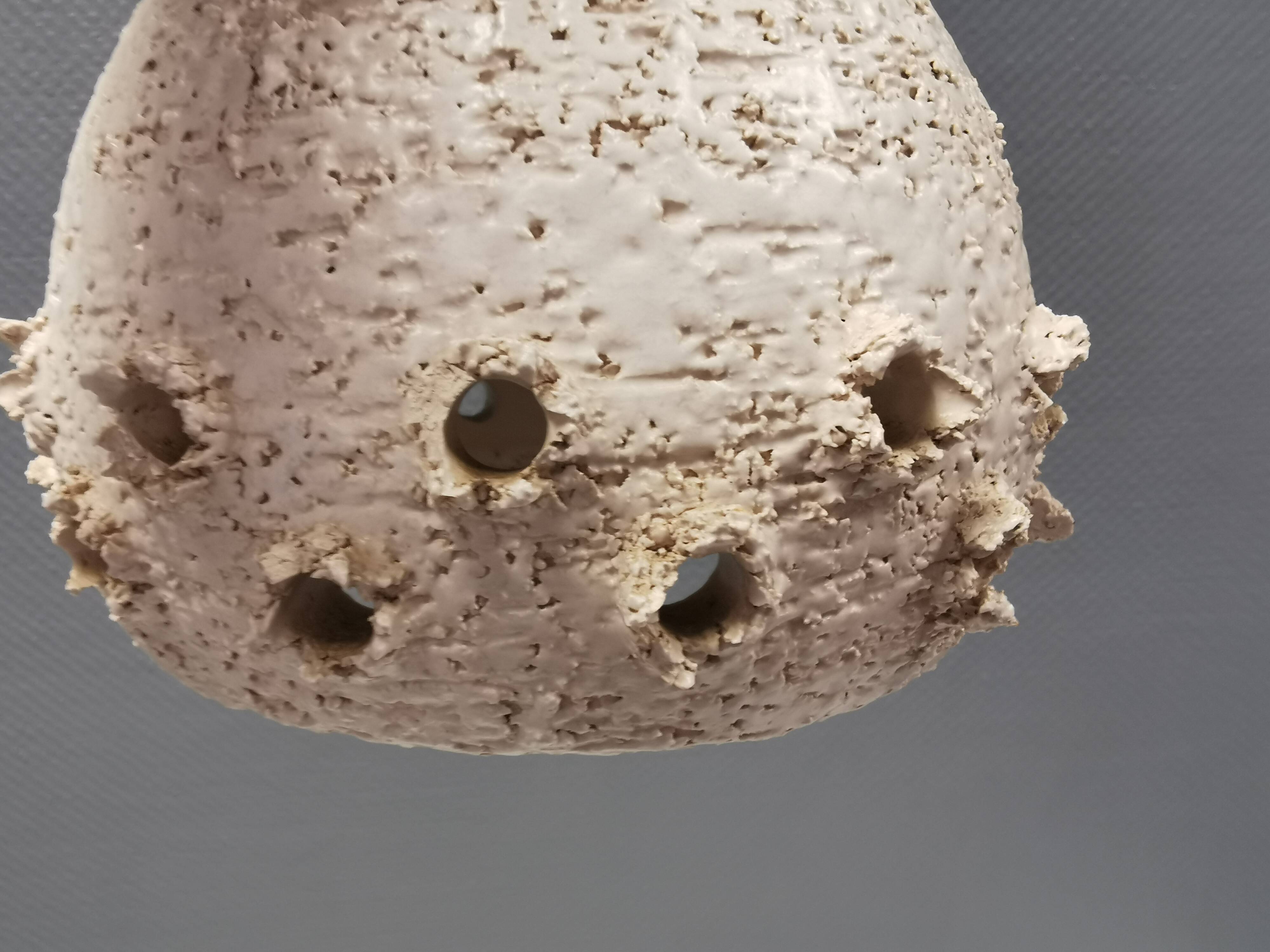 Two ceramic hanging lamps, in creamy white color, looking almost like coral